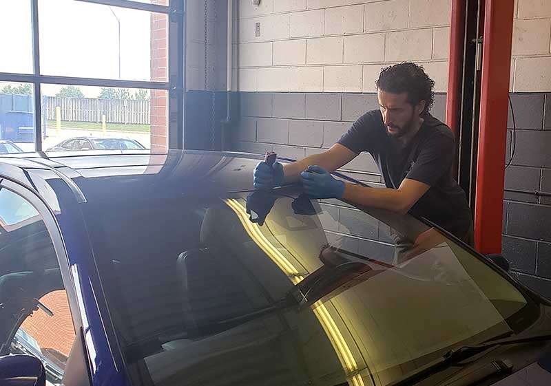 auto glass work gallery Burlington technician taking windshield off by Speers Auto Glass