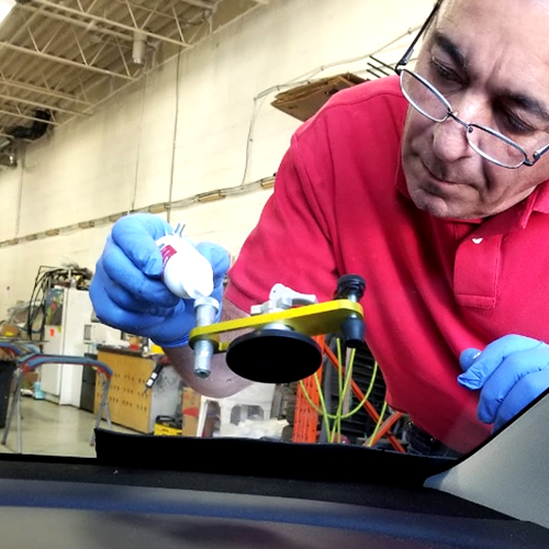 Speers Auto Glass technician reparing customer car windshield chips inside the shop