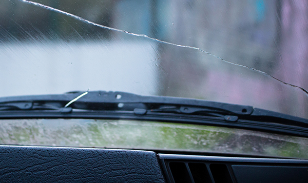 closed up shot of a long crack on the front windshield of our customer car by Speers Auto Glass